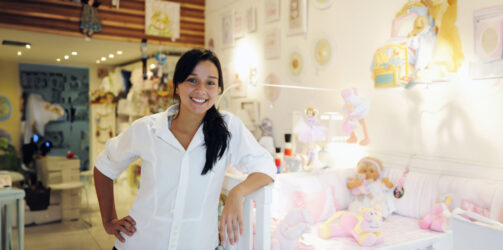 portait of small business owner: proud woman opening her baby shop